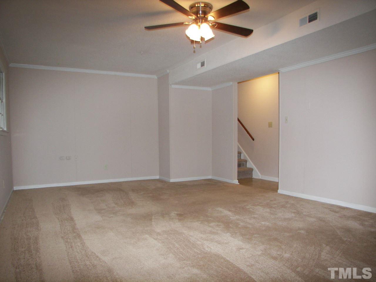 6729 Johnsdale Road Raleigh, NC 27615 - Photo 17 of 25 a view of an empty room with a chandelier fan