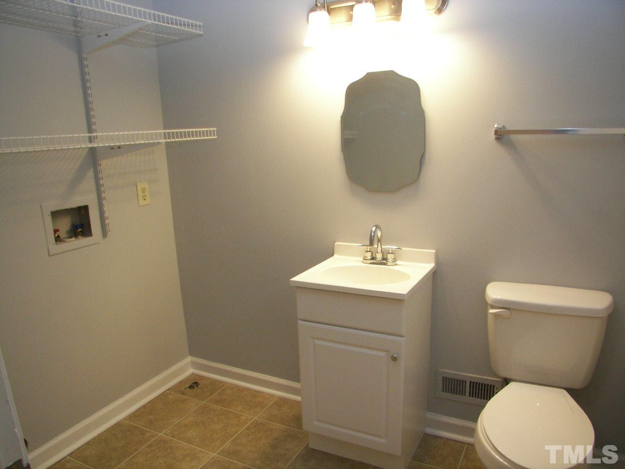 6729 Johnsdale Road Raleigh, NC 27615 - Photo 19 of 25 a bathroom with a toilet and a sink
