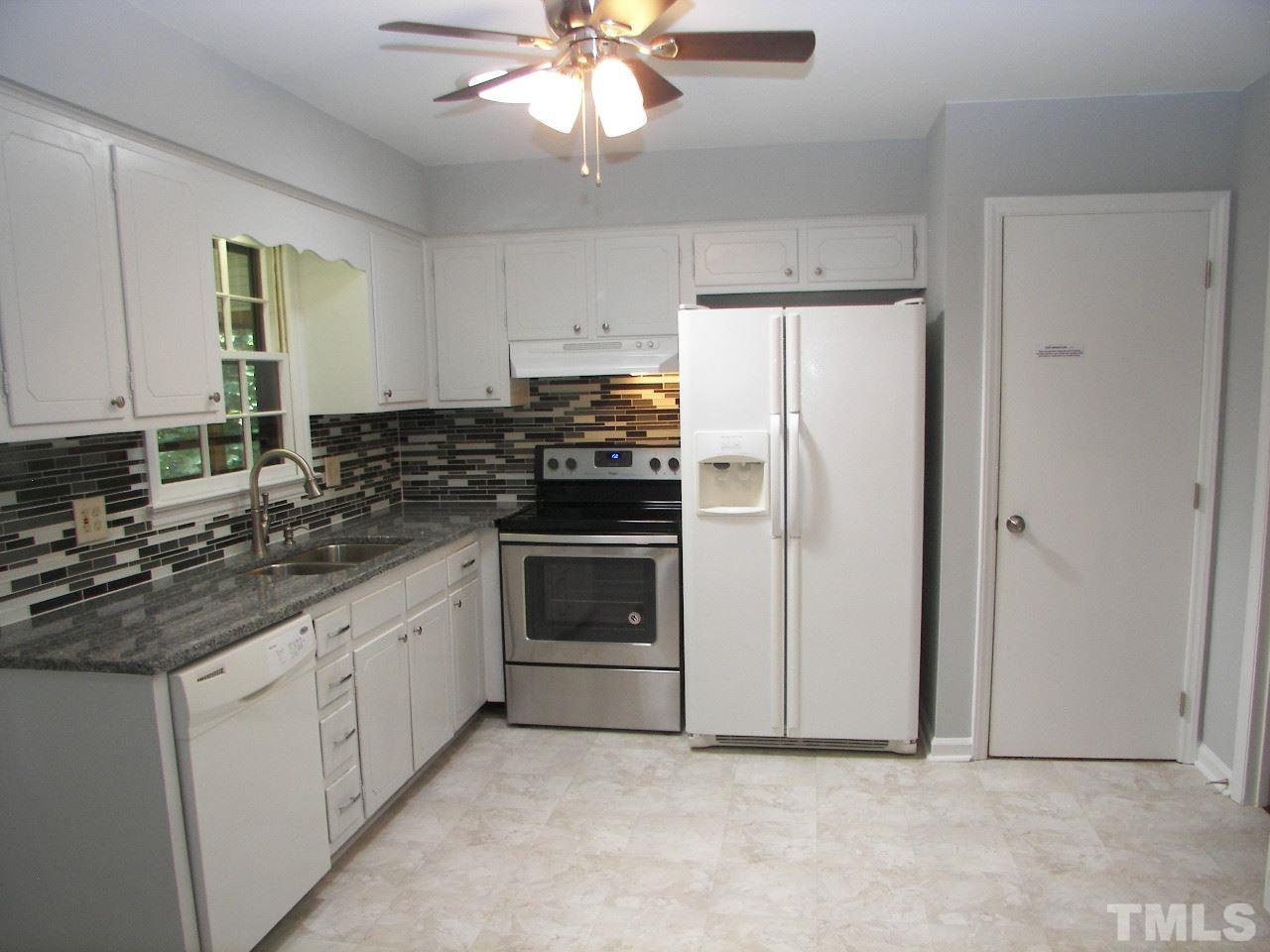 6729 Johnsdale Road Raleigh, NC 27615 - Photo 4 of 25 a kitchen with cabinets stainless steel appliances and a window