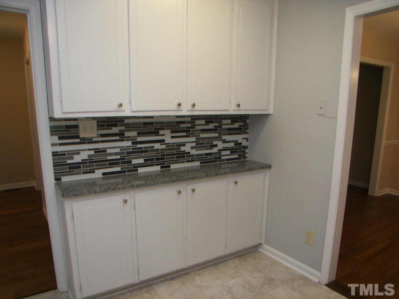 6729 Johnsdale Road Raleigh, NC 27615 - Photo 6 of 25 a close view of a stove a microwave and cabinets