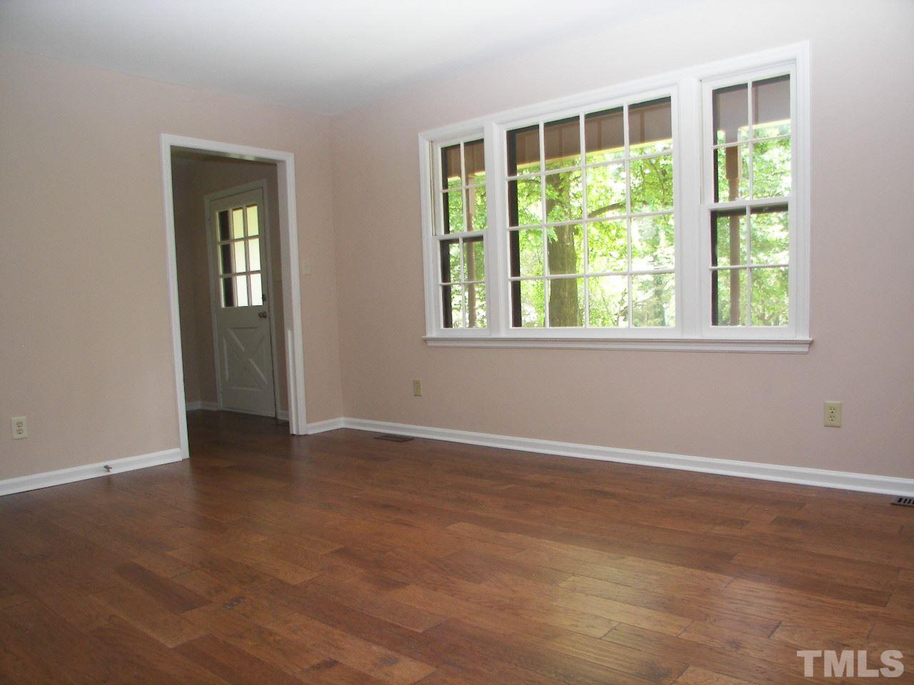 6729 Johnsdale Road Raleigh, NC 27615 - Photo 9 of 25 an empty room with wooden floor and windows
