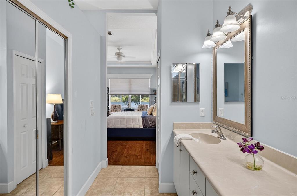 8 Hidden Lake Way Palm Coast, FL 32137 - Photo 29 of 46 a en suite bathroom with a granite countertop sink and a mirror