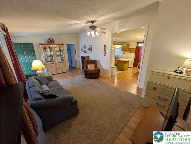 a living room with furniture and a chandelier