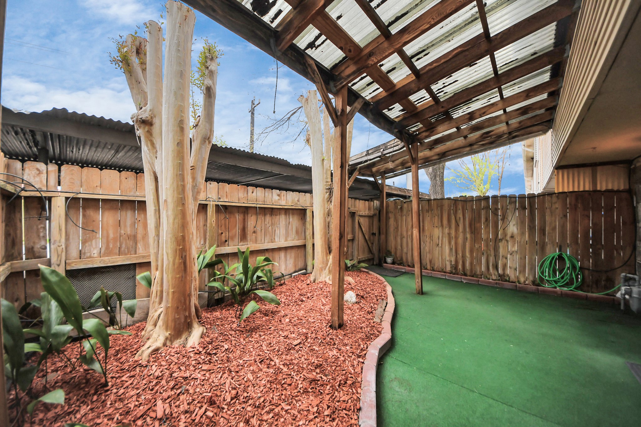 8234 Fondren Road, Unit 8234 Houston, TX 77074 - Photo 9 of 10 a view of a backyard with potted plants