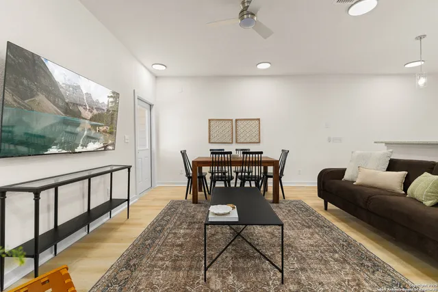 a dining room with furniture a rug and a painting