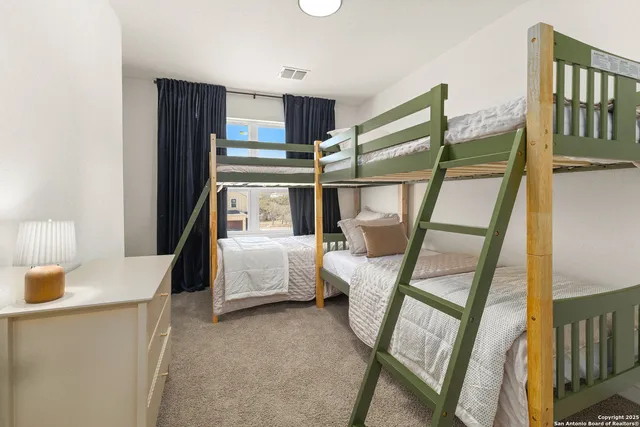 a bedroom with furniture and a window