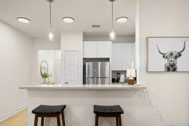 a kitchen with a table and chairs in it