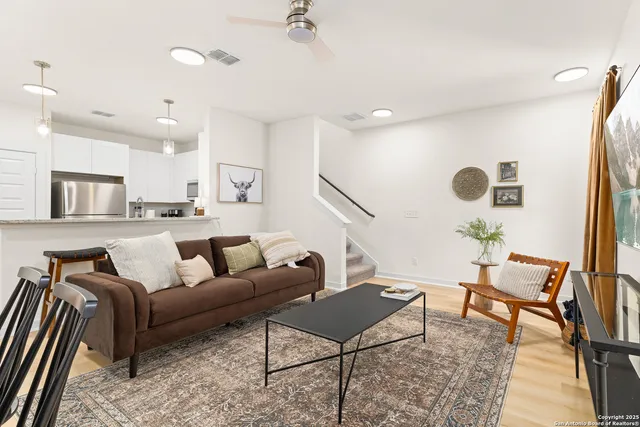a living room with furniture and a potted plant