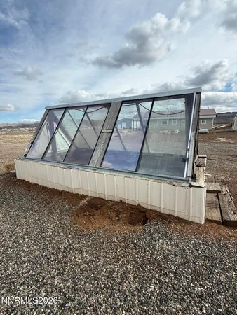 a view of a house with a car parked