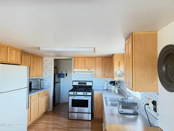 a kitchen with a refrigerator a washer and dryer
