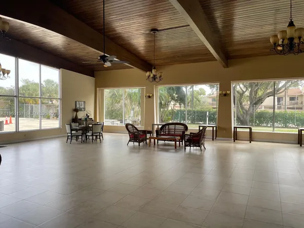 a view of a patio with table and chairs next to a large window