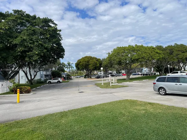 a view of outdoor space with swimming pool and trees in the background