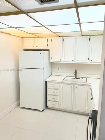 a kitchen with cabinets appliances and a sink