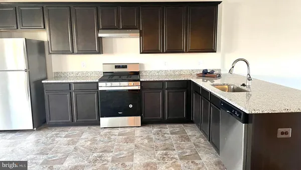 a kitchen with a sink stove and cabinets