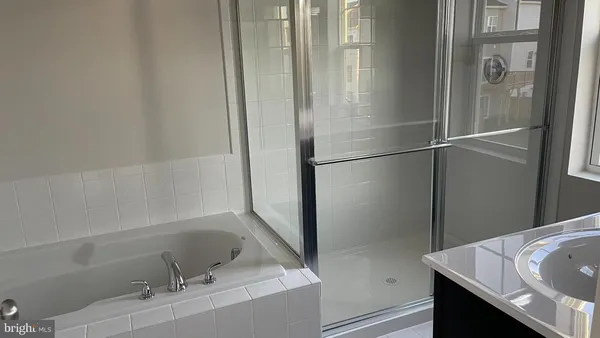 a bathroom with a bathtub and a sink