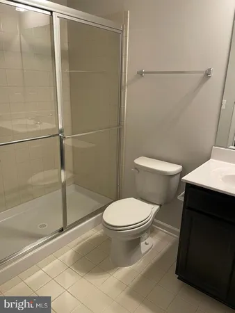 a white toilet sitting next to a bath tub