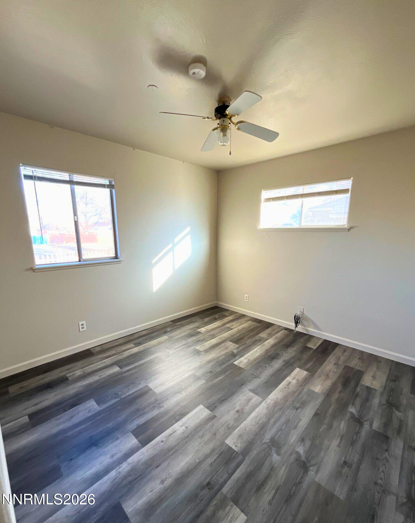 2390 Nelson Way Sparks, NV 89431 - Photo 11 of 16 a view of empty room with wooden floor and fan