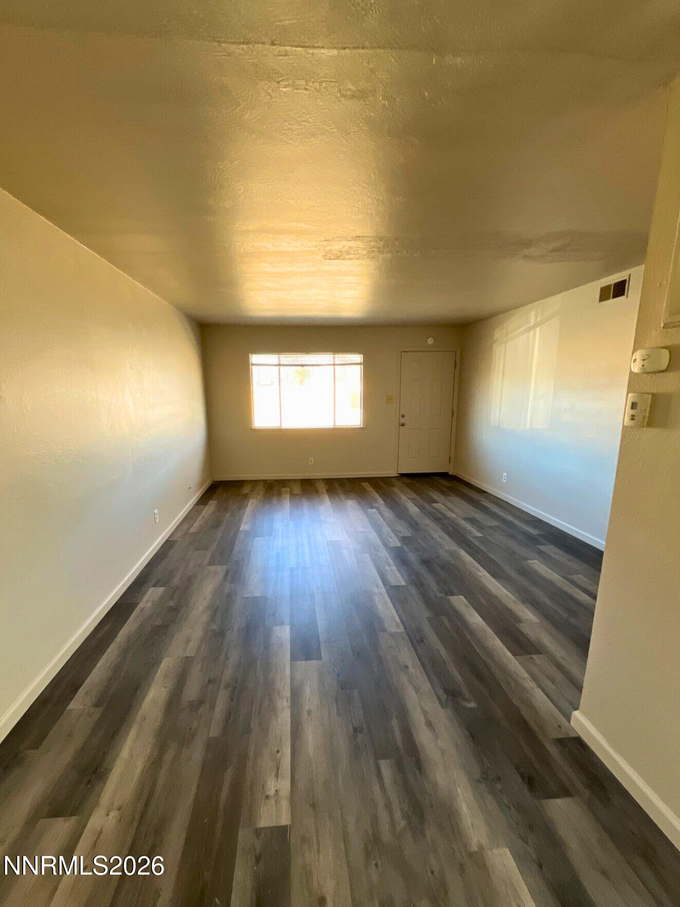 2390 Nelson Way Sparks, NV 89431 - Photo 3 of 16 wooden floor in an empty room with a window