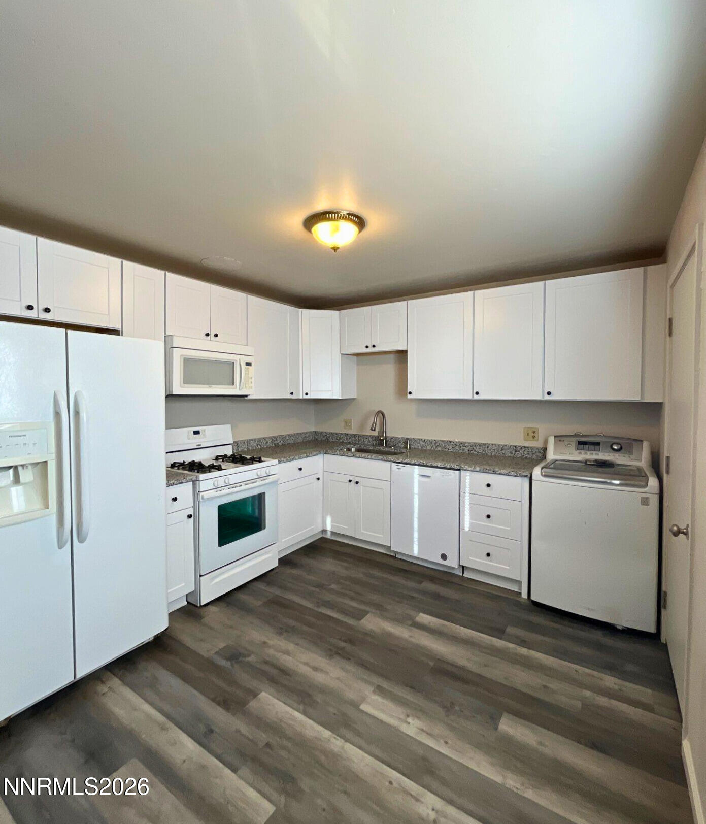 2390 Nelson Way Sparks, NV 89431 - Photo 5 of 16 a kitchen with granite countertop white cabinets and white appliances