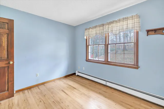 a view of a room with window and wooden floor