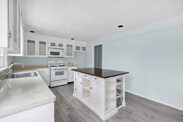 a kitchen with granite countertop a sink and cabinets