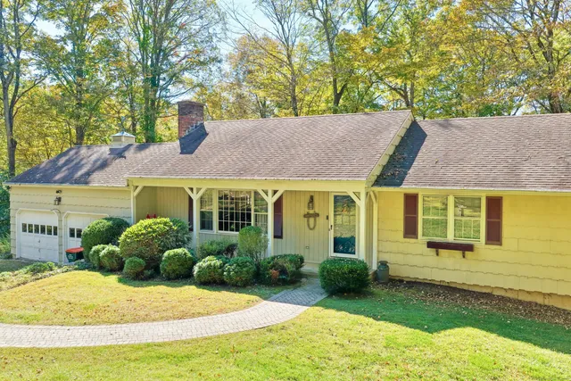 a view of a house with a garden and pathway