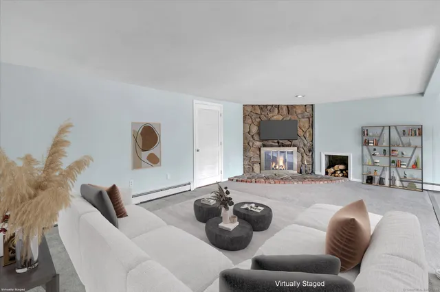 an empty room with wooden floor and fan