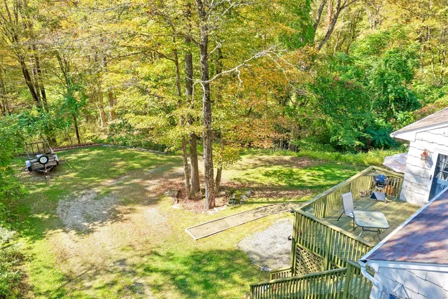 a view of a backyard with a table and chairs under an umbrella