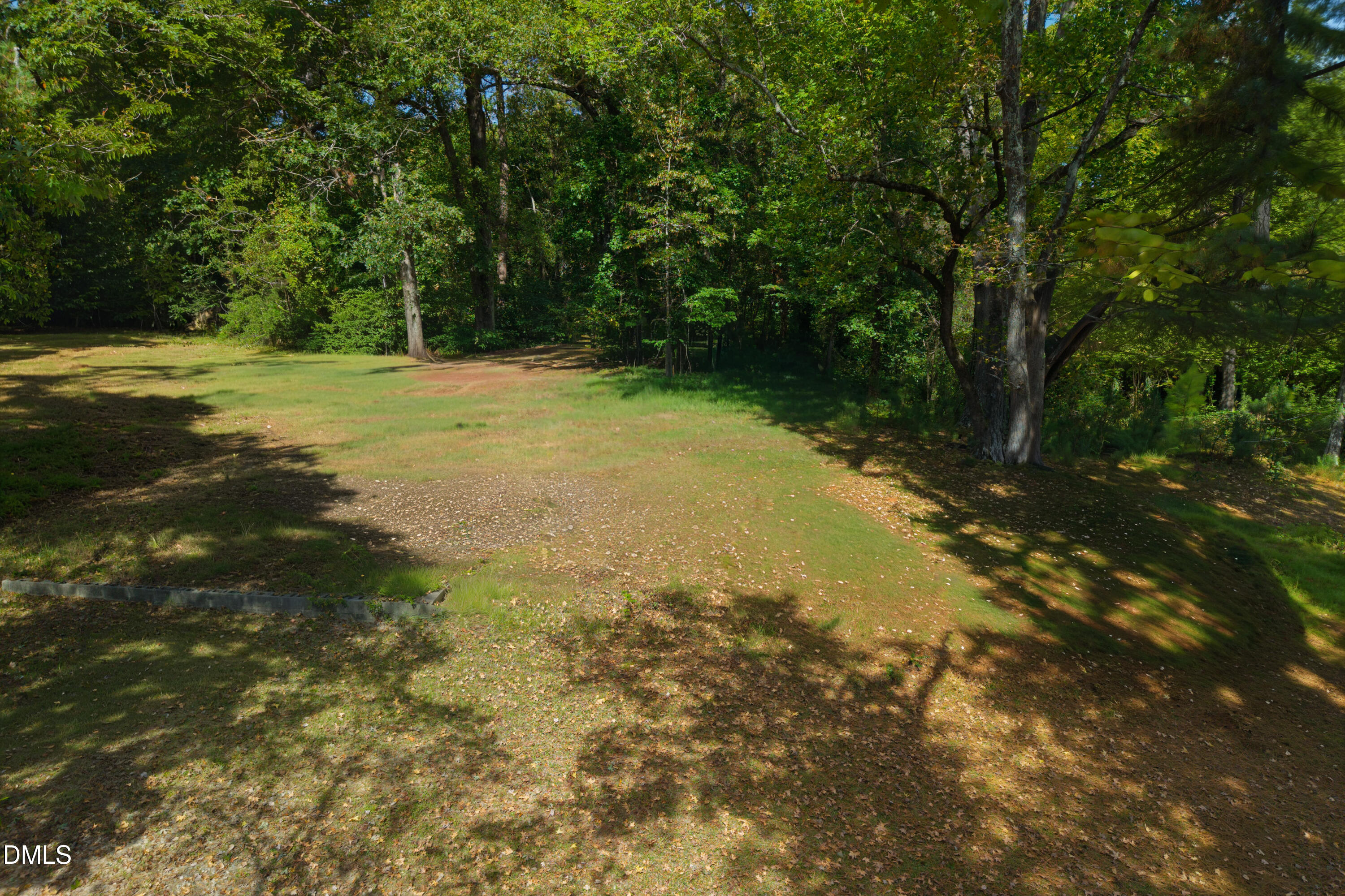 2120 Sanderford Road Raleigh, NC 27610 - Photo 9 of 18 a view of a field with trees in the background