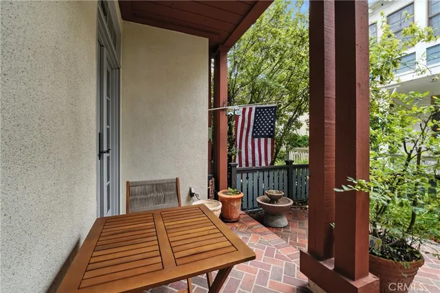 a view of a patio with chairs and plants