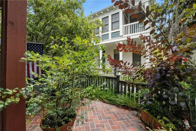 a view of a backyard with table and chairs and potted plants