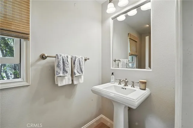 a kitchen with stainless steel appliances granite countertop a refrigerator a sink a stove and white cabinets