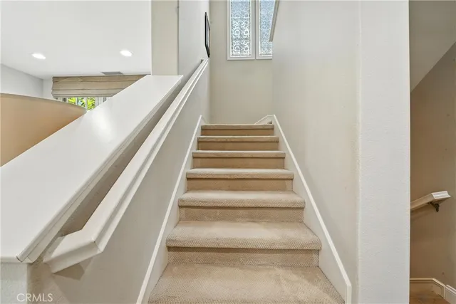 a spacious bedroom with a bed and a chandelier