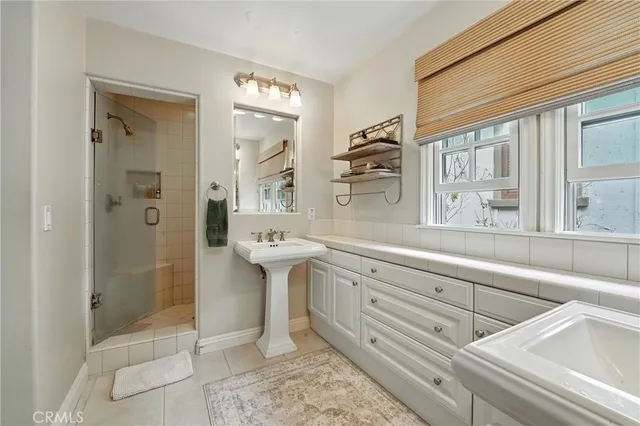 a spacious bedroom with a bed and wooden floor