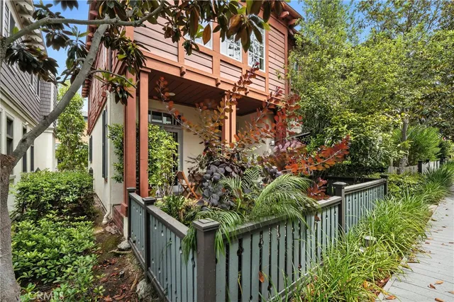 a view of a house with brick walls and flower plants