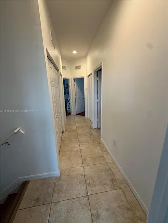 a view of hallway with a bathtub and a shower