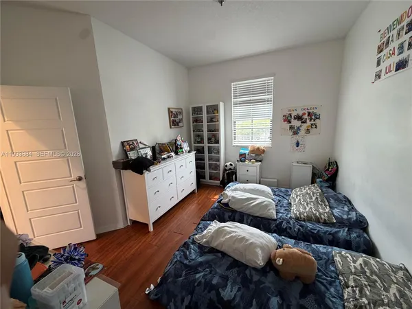 a bedroom with furniture and wooden floor