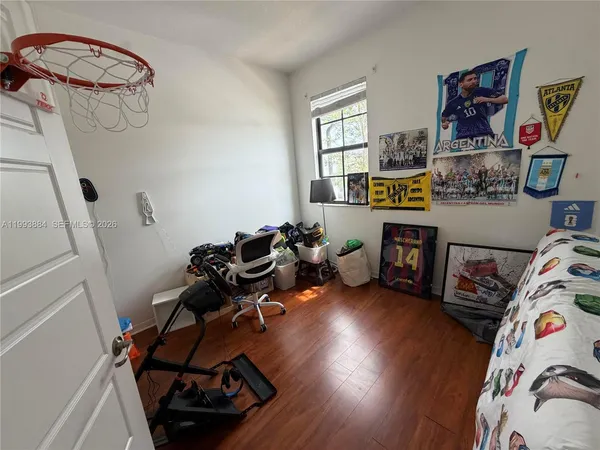 a bedroom with furniture and a wooden floor