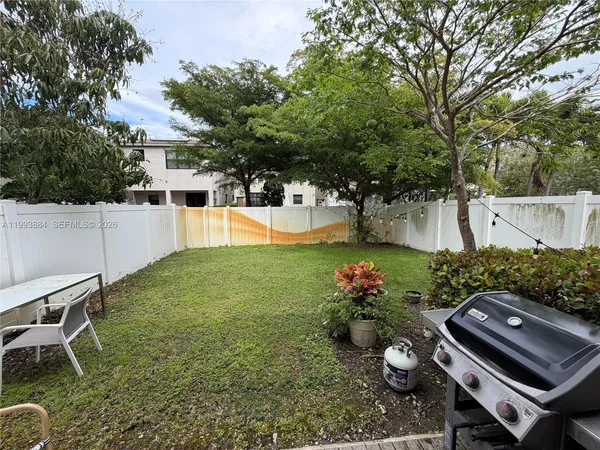 a view of a backyard with furniture and a patio