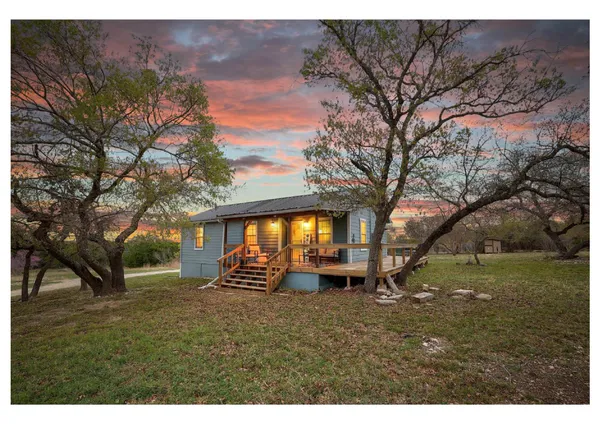 a view of patio with couple of couch and chairs