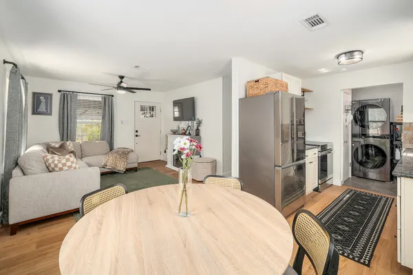 a kitchen with stainless steel appliances granite countertop a refrigerator a stove and a sink