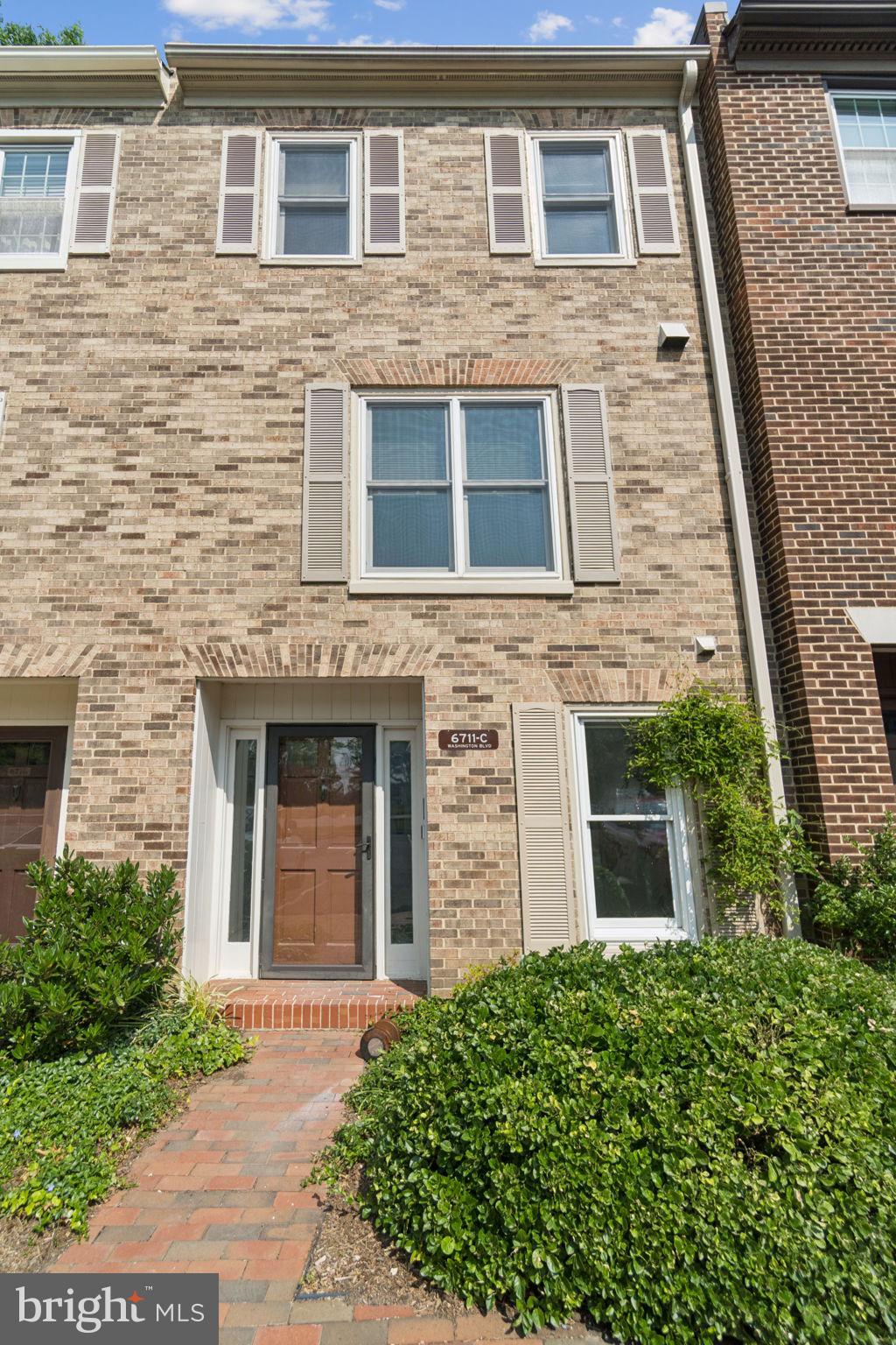 front view of a brick house with a large windows