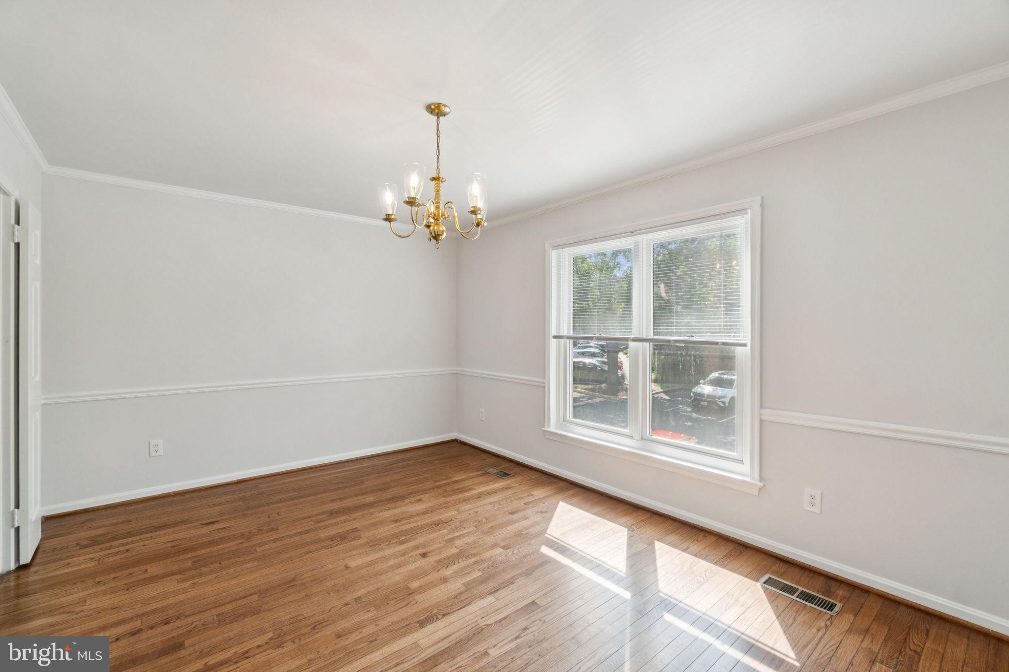6711 Washington Boulevard, Unit C Arlington, VA 22205 - Photo 11 of 30 a view of empty room with wooden floor and fan