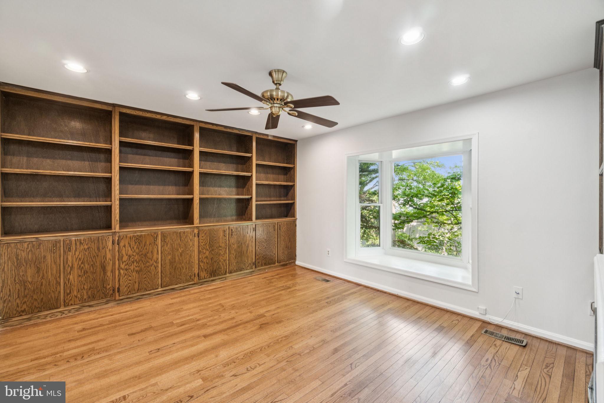 6711 Washington Boulevard, Unit C Arlington, VA 22205 - Photo 14 of 30 a view of an empty room with a window and wooden floor