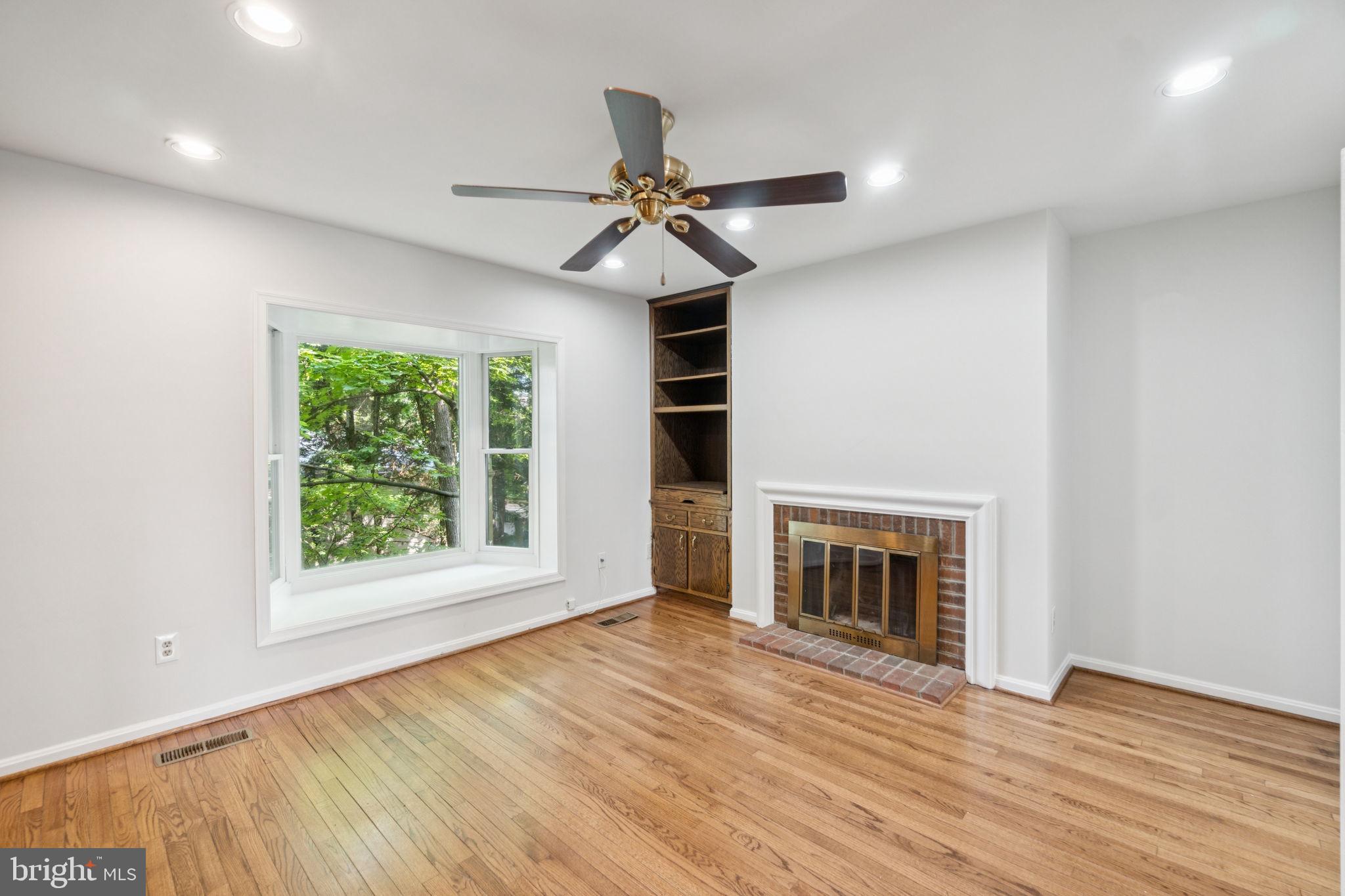 6711 Washington Boulevard, Unit C Arlington, VA 22205 - Photo 15 of 30 an empty room with windows fireplace and fan