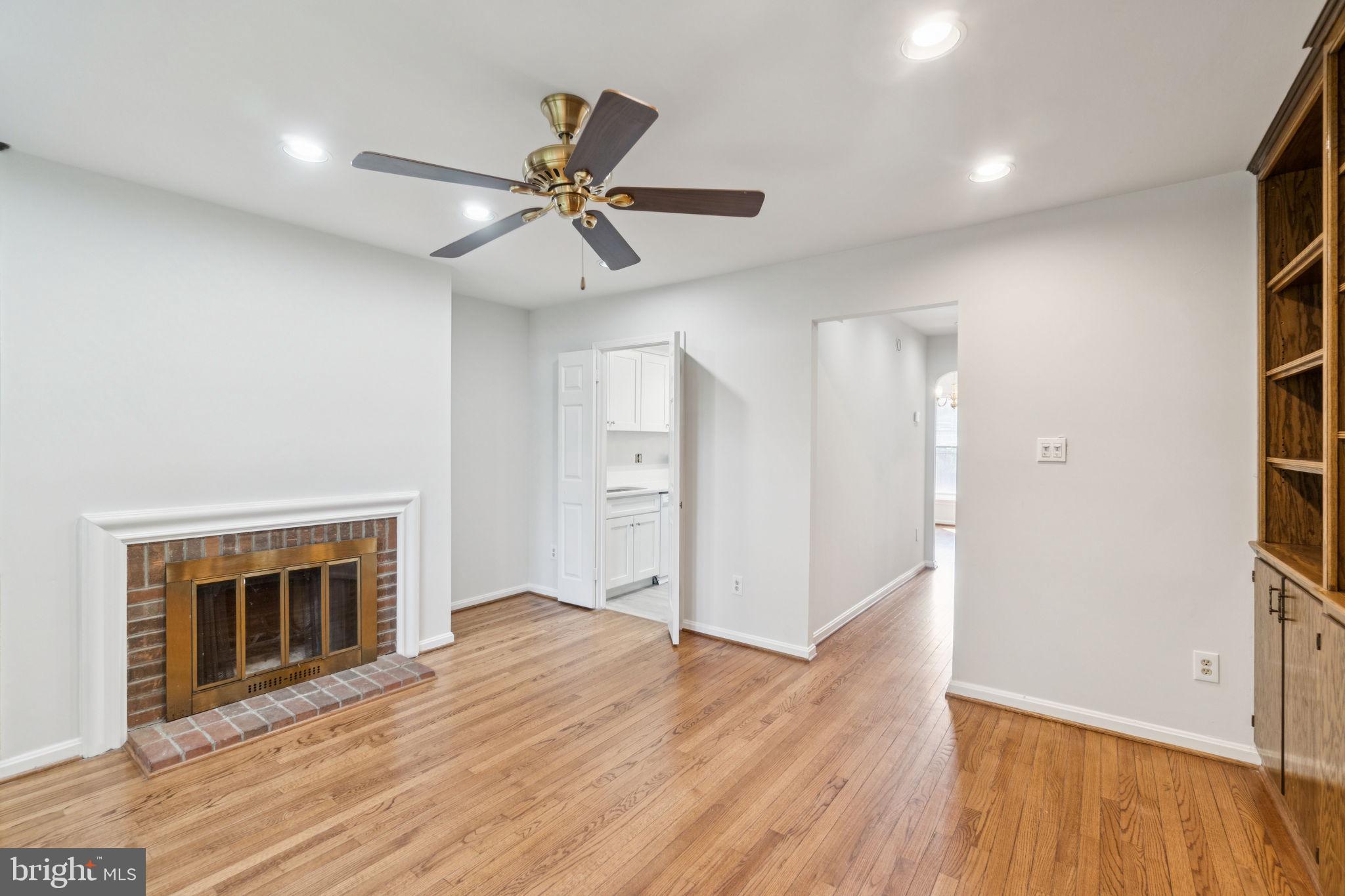 6711 Washington Boulevard, Unit C Arlington, VA 22205 - Photo 16 of 30 a view of an empty room with wooden floor fireplace and a window
