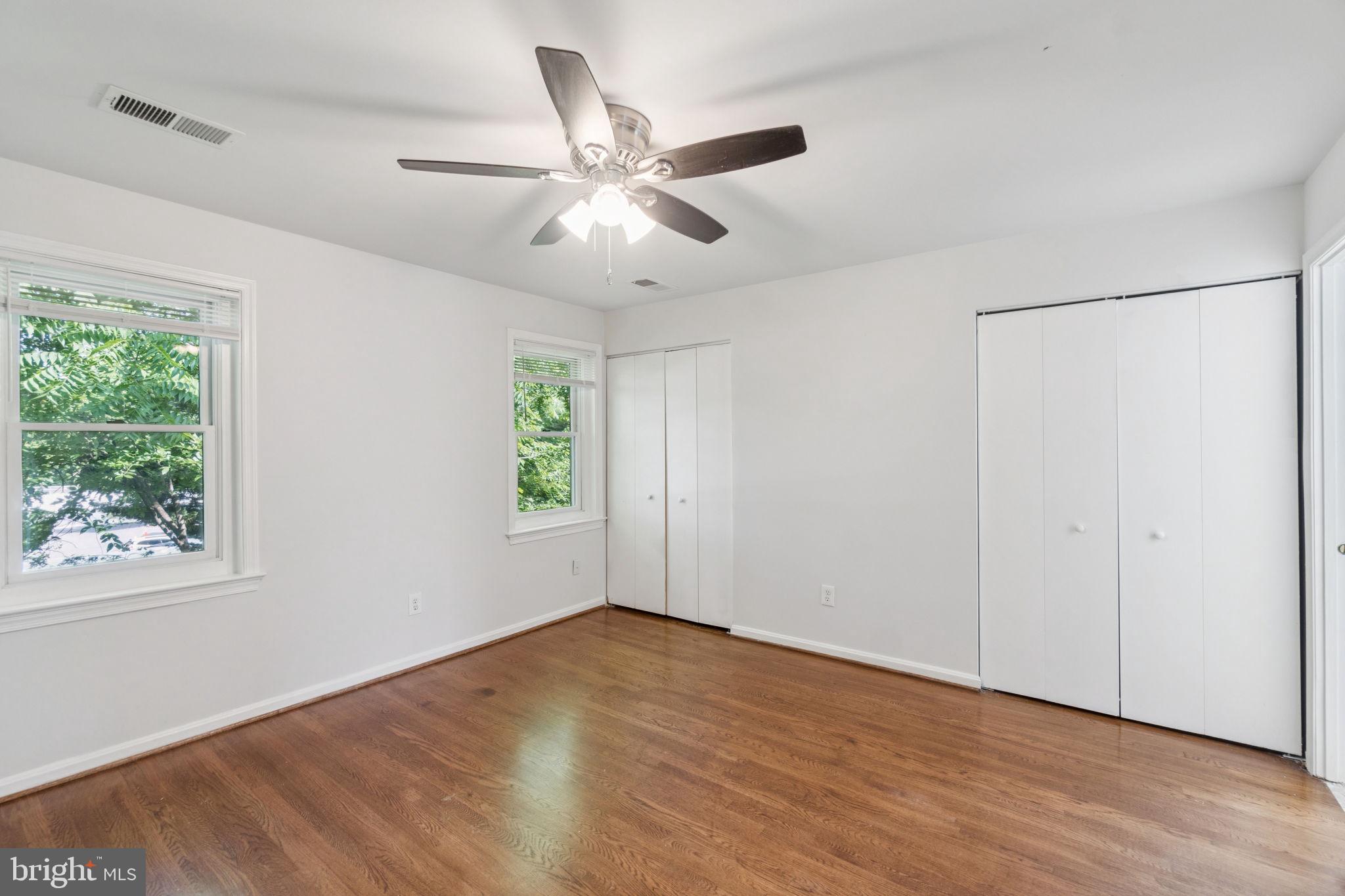 6711 Washington Boulevard, Unit C Arlington, VA 22205 - Photo 20 of 30 a view of an empty room with wooden floor and a window
