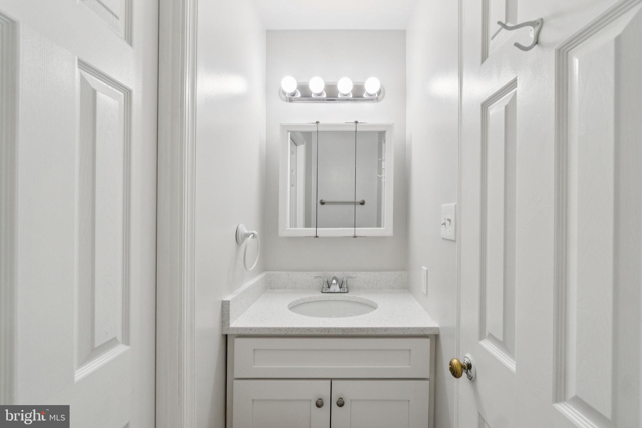6711 Washington Boulevard, Unit C Arlington, VA 22205 - Photo 23 of 30 a bathroom with a sink and a mirror
