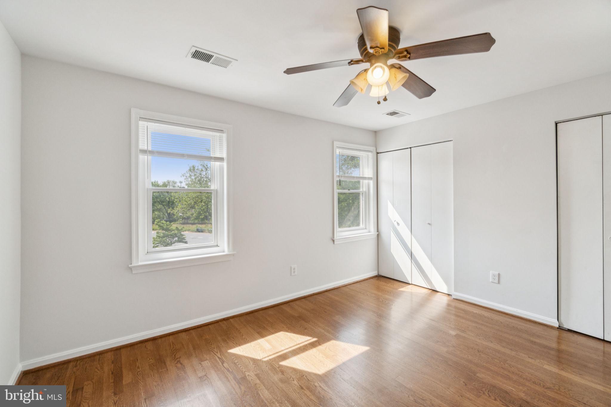 6711 Washington Boulevard, Unit C Arlington, VA 22205 - Photo 25 of 30 a view of an empty room with window and wooden floor