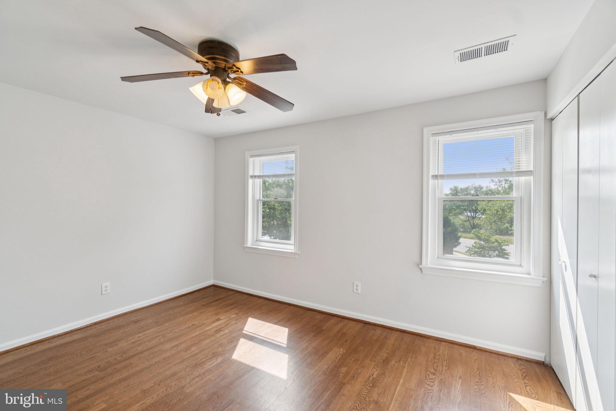 6711 Washington Boulevard, Unit C Arlington, VA 22205 - Photo 27 of 30 a view of an empty room with wooden floor and a window